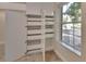Bright room with ample storage, featuring built-in drawers and cabinets next to window at 117 N Garfield Ave # 16, Deland, FL 32724