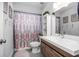 Updated bathroom featuring modern vanity, decorative shower curtain, and tiled floor at 1369 Saxon Blvd, Deltona, FL 32725