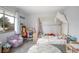 Bright bedroom featuring a charming canopy bed and a cozy sitting area at 1369 Saxon Blvd, Deltona, FL 32725