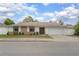 Inviting single-story home with stone accents, double-door entry, manicured lawn, and a two-car garage at 1369 Saxon Blvd, Deltona, FL 32725