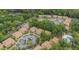 Aerial view of condo complex with lush landscaping, common areas and community pool at 140 Orchid Woods Ct # 14B, Deltona, FL 32725