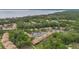 Aerial view of the community buildings nestled among lush greenery near a scenic lake at 140 Orchid Woods Ct # 14B, Deltona, FL 32725