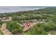 Aerial view with locator pin of the community buildings nestled among lush greenery near a scenic lake at 140 Orchid Woods Ct # 14B, Deltona, FL 32725