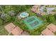 Aerial view showcasing the community pool and tennis courts amongst lush landscaping at 140 Orchid Woods Ct # 14B, Deltona, FL 32725