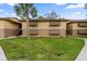 View of the condo with green grass, a walkway, and charming window awnings for curb appeal at 140 Orchid Woods Ct # 14B, Deltona, FL 32725