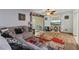Cozy living room with wood floors, a ceiling fan, and a sliding glass door to a balcony at 140 Orchid Woods Ct # 14B, Deltona, FL 32725