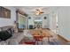 Cozy living room featuring wood floors, a ceiling fan, and a sliding glass door to a balcony at 140 Orchid Woods Ct # 14B, Deltona, FL 32725