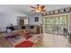 Comfortable living room featuring modern wood flooring, and a sliding glass door leading to a screened in balcony at 140 Orchid Woods Ct # 14B, Deltona, FL 32725