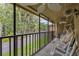 Inviting screened-in porch with rocking chairs and a hammock overlooking lush greenery at 140 Orchid Woods Ct # 14B, Deltona, FL 32725