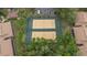 Aerial view of well-maintained community tennis courts surrounded by greenery at 140 Orchid Woods Ct # 14B, Deltona, FL 32725