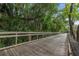 A scenic wooden walkway surrounded by lush greenery offers a tranquil escape in the community at 140 Orchid Woods Ct # 14B, Deltona, FL 32725