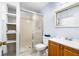 Well-lit bathroom featuring a glass enclosed shower and a vanity with a wooden cabinet at 1426 Saxon Blvd, Deltona, FL 32725