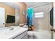 Well-lit bathroom featuring a tub and shower with a colorful, decorative shower curtain at 1426 Saxon Blvd, Deltona, FL 32725