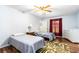 Bright bedroom features two twin beds, wood floors, and a ceiling fan at 1426 Saxon Blvd, Deltona, FL 32725
