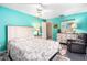 This beautiful bedroom features turquoise walls, plush carpeting, and closet doors at 1426 Saxon Blvd, Deltona, FL 32725