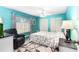 This stylish bedroom features turquoise walls, plush carpeting, and closet doors at 1426 Saxon Blvd, Deltona, FL 32725