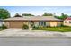 Charming home exterior with stone accents, well-maintained landscaping, and an attached garage at 1426 Saxon Blvd, Deltona, FL 32725