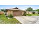 Home exterior showcasing the attached garage, stone facade, and landscaped yard at 1426 Saxon Blvd, Deltona, FL 32725