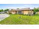 Well-kept front yard with a green lawn and charming home exterior with decorative stone at 1426 Saxon Blvd, Deltona, FL 32725