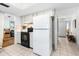Well-equipped kitchen with white cabinets, appliances, and easy access to the home's entrance and living areas at 1426 Saxon Blvd, Deltona, FL 32725