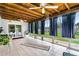 Enclosed sunroom featuring tile flooring, a wood beam ceiling, and large windows with backyard views at 1426 Saxon Blvd, Deltona, FL 32725