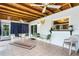Sunroom featuring neutral tile flooring, a decorative butterfly, and outdoor access at 1426 Saxon Blvd, Deltona, FL 32725