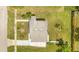 Aerial view of a compact home highlighting its roof, yard, and surrounding greenery at 1479 Renton St, Deltona, FL 32725