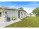 The backyard features a green lawn, a back door entrance, and a green bench at 1479 Renton St, Deltona, FL 32725