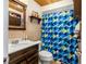Well-maintained bathroom with modern fixtures, a patterned shower curtain, and tiled walls at 1479 Renton St, Deltona, FL 32725