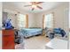 Cozy bedroom featuring a comfortable bed, natural light, and a ceiling fan at 1479 Renton St, Deltona, FL 32725