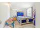 The bedroom has a plush blue bed frame and a small side table with a nightstand at 1479 Renton St, Deltona, FL 32725