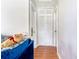 Bright hallway with hardwood floors, a closet, and a glimpse of a cozy sofa at 1479 Renton St, Deltona, FL 32725