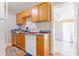 Practical kitchen featuring wooden cabinetry, updated appliances, and laminate flooring at 1479 Renton St, Deltona, FL 32725