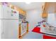 This kitchen features wood cabinets, white appliances, and a light blue countertop at 1479 Renton St, Deltona, FL 32725