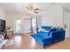 Cozy living room with a plush blue sectional, bright lighting, and laminate flooring at 1479 Renton St, Deltona, FL 32725