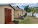 The spacious backyard includes a shed, pool equipment, a white fence, and a palm tree at 1491 E Palomar Dr, Deltona, FL 32738