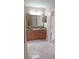 Bathroom featuring double sink vanity with granite countertop and tile floors at 1491 E Palomar Dr, Deltona, FL 32738