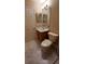 Bathroom with tile flooring, vanity, toilet, and a decorative mirror at 1491 E Palomar Dr, Deltona, FL 32738