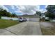 Home exterior showing the driveway and garage with a fenced in yard at 1491 E Palomar Dr, Deltona, FL 32738