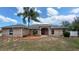 Charming brick home with a well-manicured front yard and inviting entryway at 1491 E Palomar Dr, Deltona, FL 32738