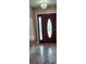 Front entry featuring a decorative glass door, chandelier, and tiled flooring, enhancing the home's curb appeal at 1491 E Palomar Dr, Deltona, FL 32738