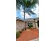 Charming home featuring a palm tree and well-maintained landscaping at 1491 E Palomar Dr, Deltona, FL 32738