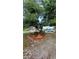 Charming front yard with gravel driveway and mature tree at 1491 E Palomar Dr, Deltona, FL 32738