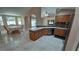 Open floorplan showing the kitchen area with stone countertops leading to the dining room at 1491 E Palomar Dr, Deltona, FL 32738