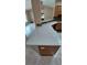 View of a kitchen counter, with granite countertops and modern lighting, extending into an open-concept living area at 1491 E Palomar Dr, Deltona, FL 32738