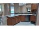 Open kitchen featuring wood cabinets, stone countertops, and stainless steel appliances at 1491 E Palomar Dr, Deltona, FL 32738