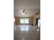Bright living room featuring tile floors, a ceiling fan, and sliding doors leading to the outdoors at 1491 E Palomar Dr, Deltona, FL 32738