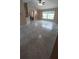 Spacious living room with tile flooring leading to the dining and kitchen areas at 1491 E Palomar Dr, Deltona, FL 32738