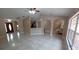 Bright, open-concept living room showcasing tile floors and arched doorways at 1491 E Palomar Dr, Deltona, FL 32738