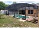 Screened in pool area with a pool, concrete deck and surrounding landscaping at 1491 E Palomar Dr, Deltona, FL 32738